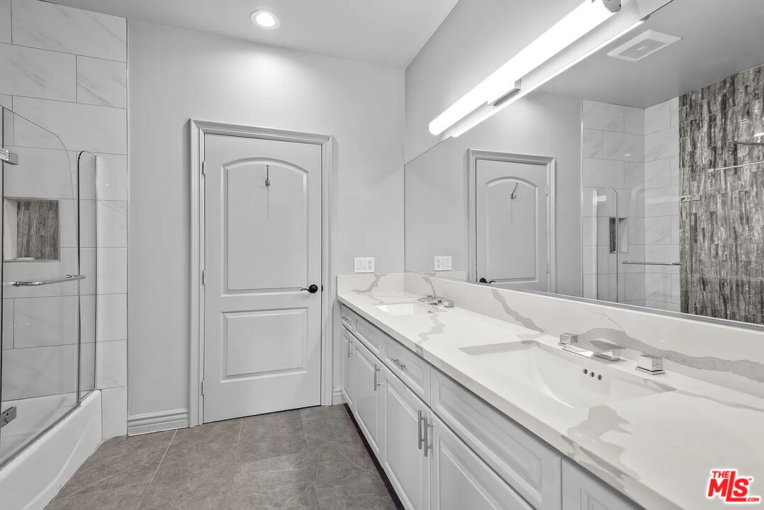 4724 Noble Avenue Sherman Oaks, CA 91403 - Photo 21 of 35 a bathroom with a double vanity sink and mirror