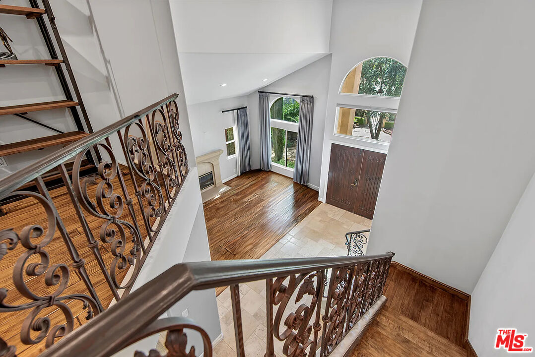 4724 Noble Avenue Sherman Oaks, CA 91403 - Photo 25 of 35 a view of a hallway with wooden floor and stairs