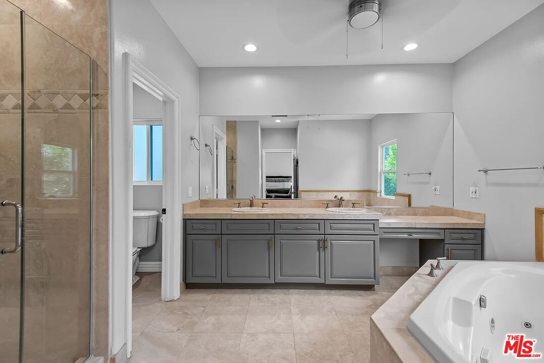 4724 Noble Avenue Sherman Oaks, CA 91403 - Photo 26 of 35 a bathroom with a tub a sink and mirror