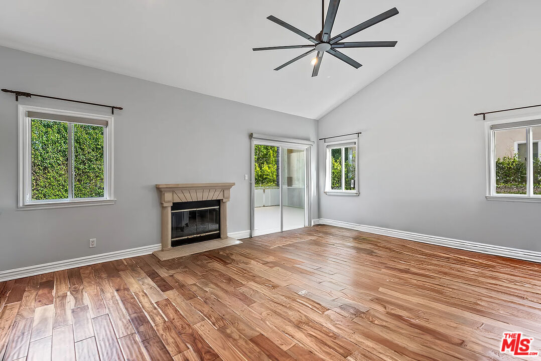 4724 Noble Avenue Sherman Oaks, CA 91403 - Photo 27 of 35 a view of empty room with wooden floor and fireplace