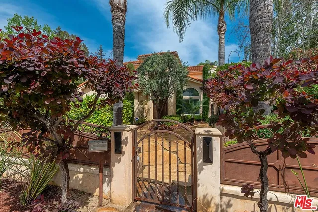 an aerial view of a house with a yard and garden