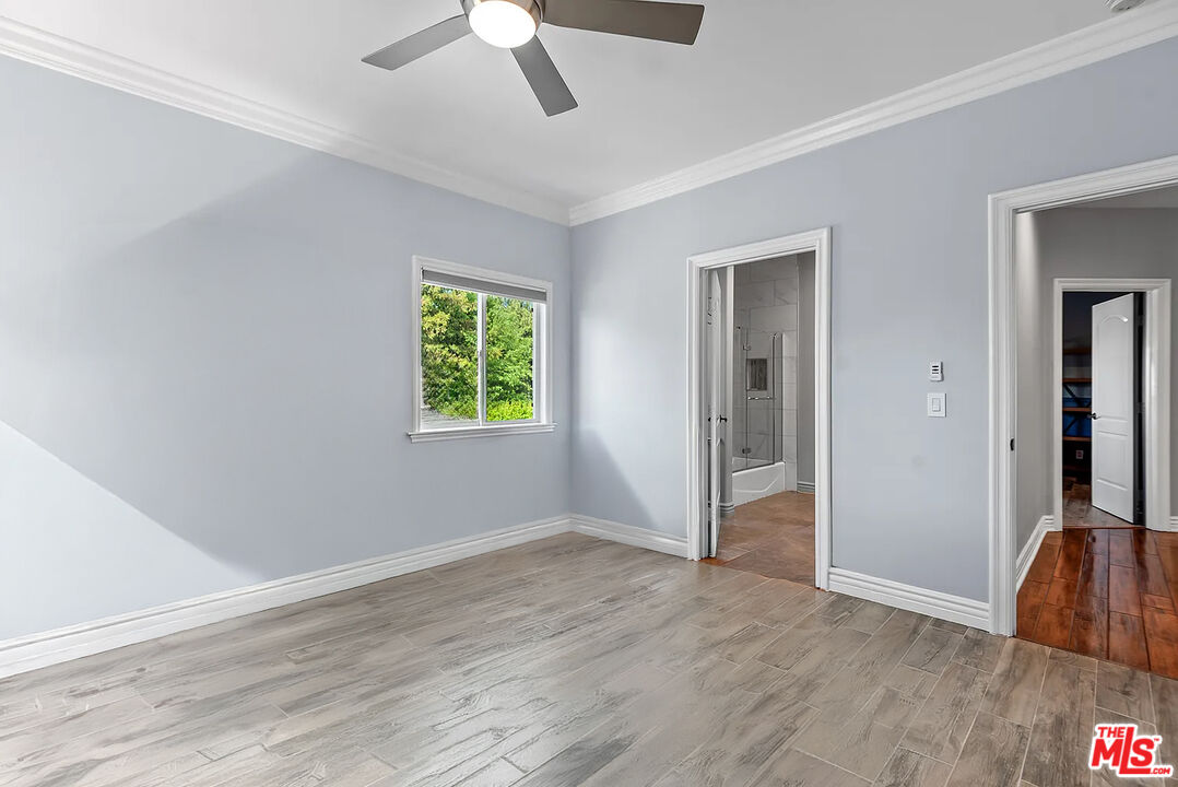 4724 Noble Avenue Sherman Oaks, CA 91403 - Photo 31 of 35 a view of an empty room with wooden floor and a window