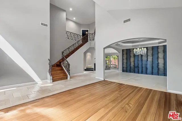 a kitchen with stainless steel appliances granite countertop a stove a sink a refrigerator and a refrigerator