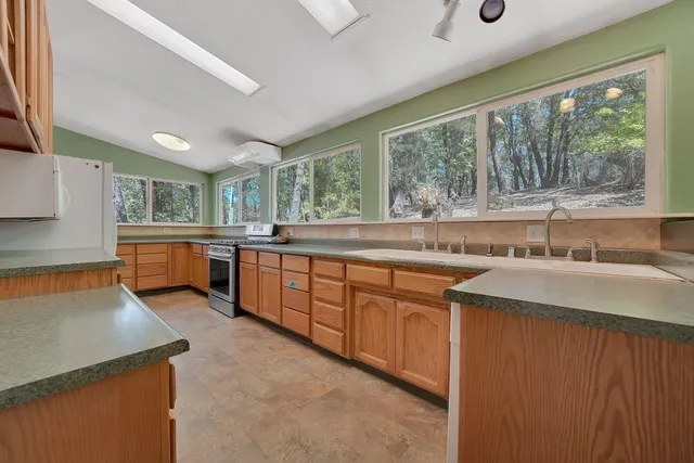 a kitchen with wooden cabinets a sink and a stove