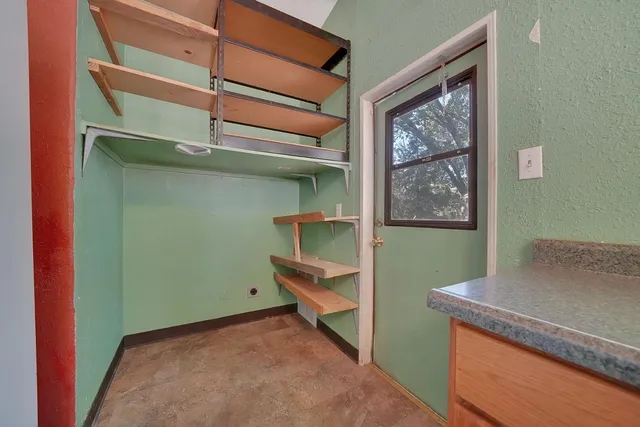 a view of room with window and furniture