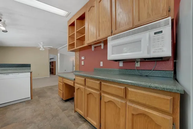 a kitchen with stainless steel appliances granite countertop a stove and a microwave