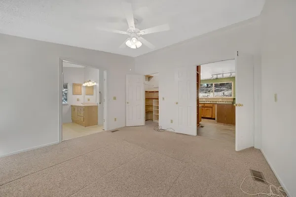 an empty room with a bathroom and a sink