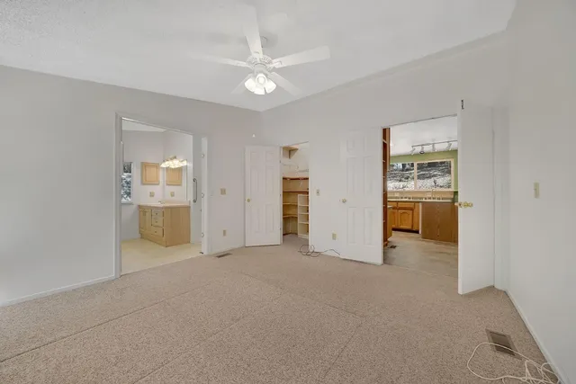 an empty room with a bathroom and a sink