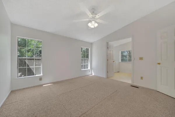 an empty room with windows and closet