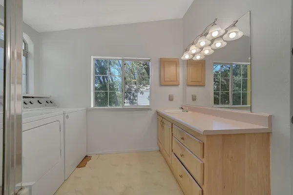 a bathroom with a sink vanity and mirror