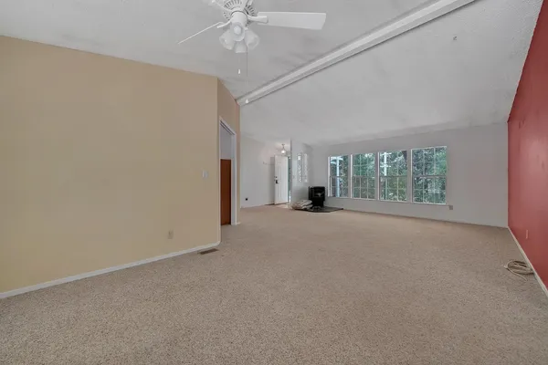 a view of a livingroom with a ceiling fan and window