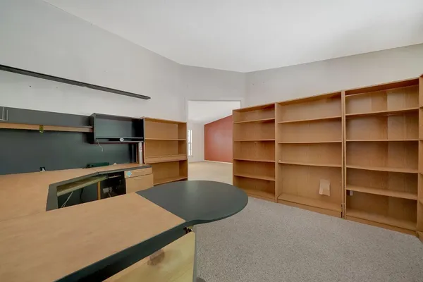 a kitchen that has a microwave and a stove top oven