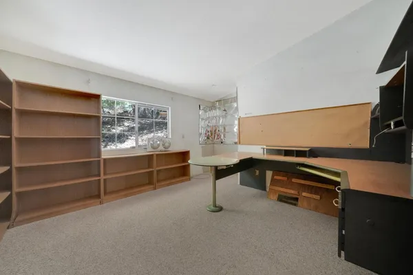 a living room with a flat screen tv and gym equipment