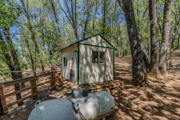 a backyard of a house with table and chairs