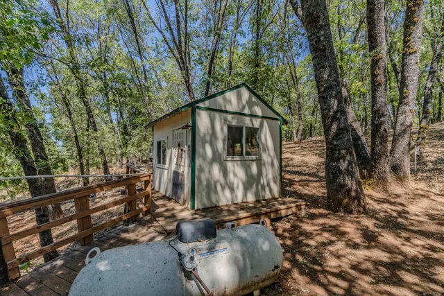 a backyard of a house with table and chairs
