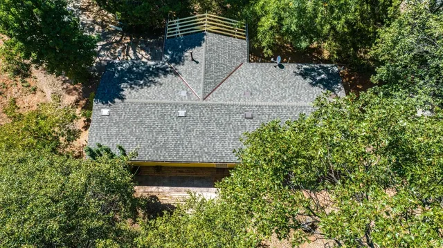 an aerial view of a house with yard