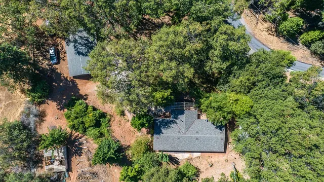 an aerial view of a house with a yard