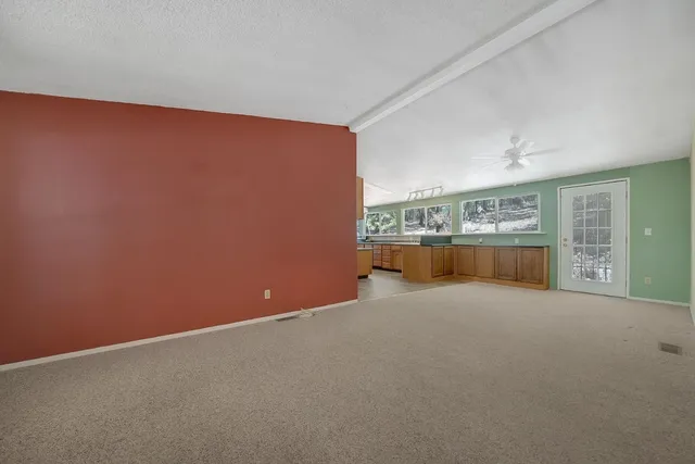 an empty room with a kitchen