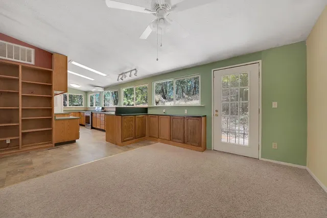 a view of an empty room with a cabinet and a window