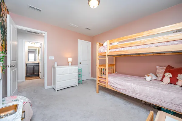 a bedroom with a bed and a desk