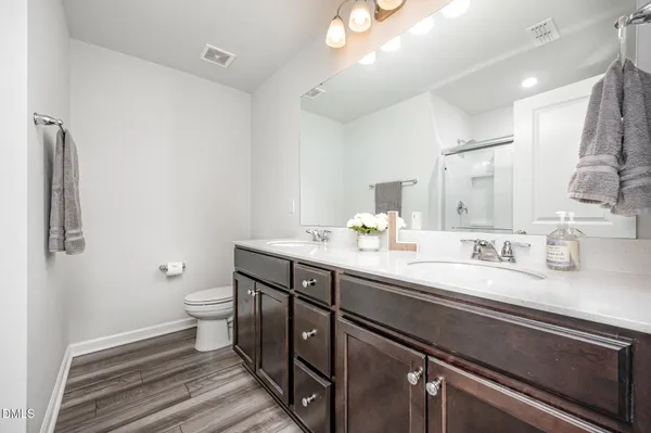 a spacious bedroom with a bed and a cabinets