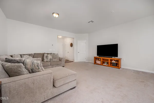 a view of hallway with table and flowers