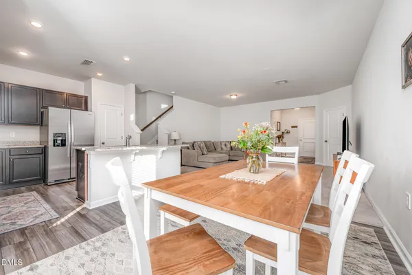 a living room with furniture and a kitchen view