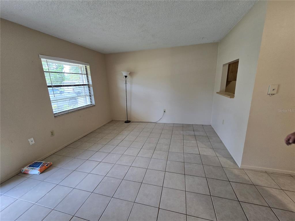 289 Jeru Boulevard, Unit 289B Tarpon Springs, FL 34689 - Photo 2 of 9 an empty room with windows