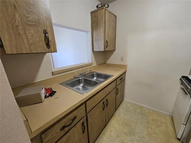 a utility room with sink dryer and washer