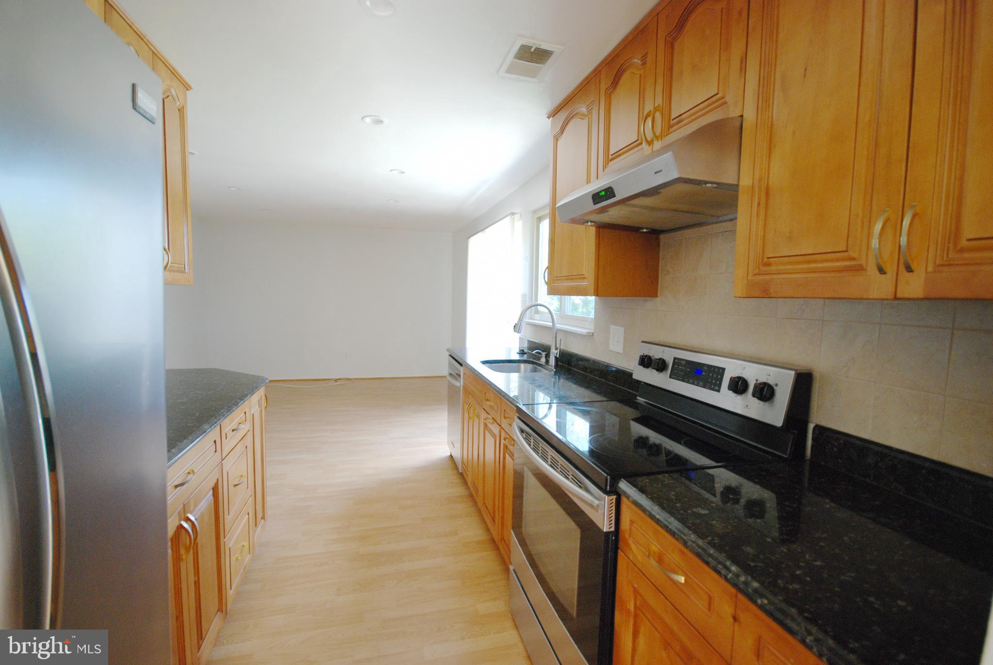 a kitchen with a stove and a refrigerator