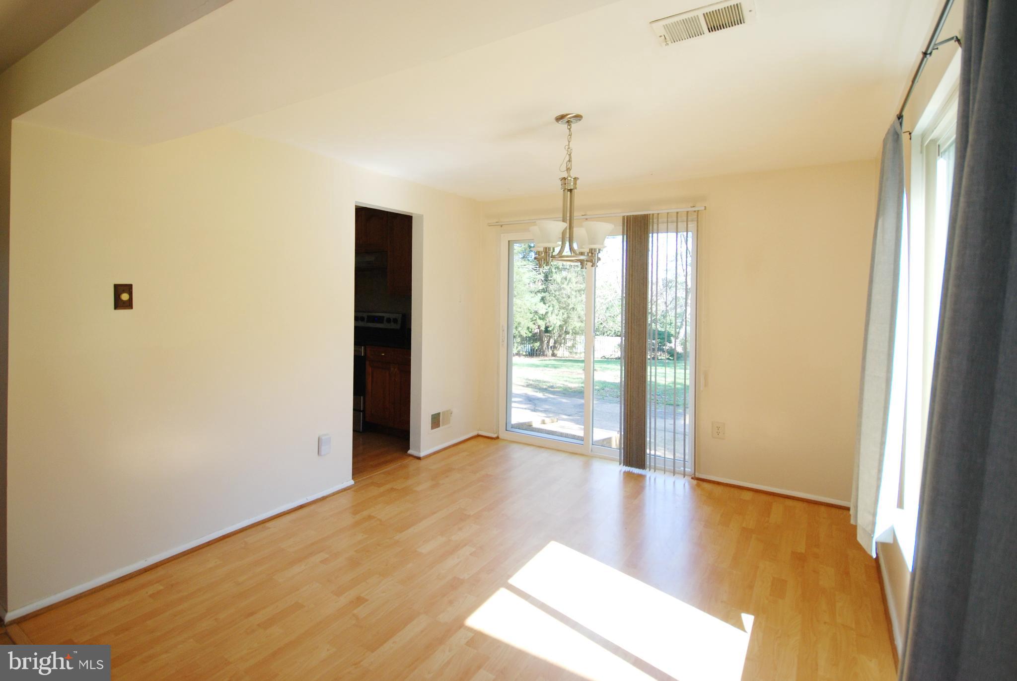 11609 Piney Lodge Road North Potomac, MD 20878 - Photo 11 of 25 a view of empty room with wooden floor and fan