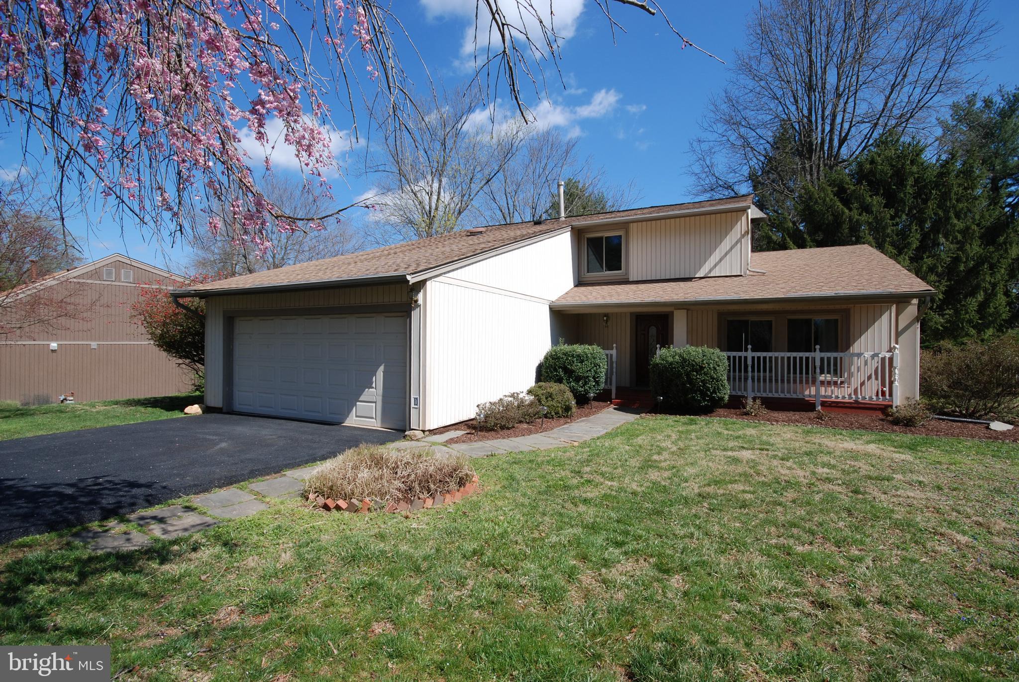 11609 Piney Lodge Road North Potomac, MD 20878 - Photo 2 of 25 a front view of a house with garden