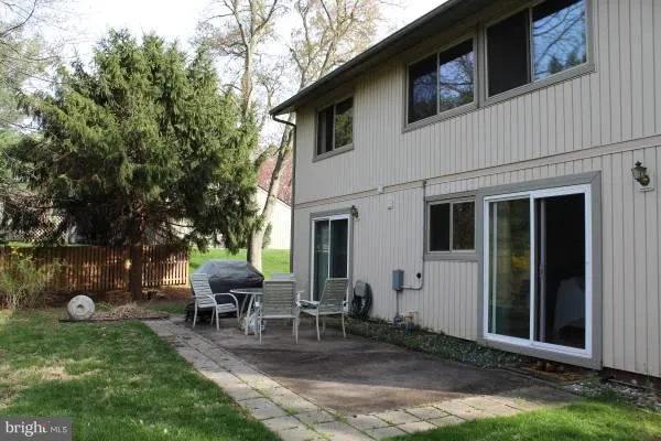 a view of a house with backyard sitting area and garden