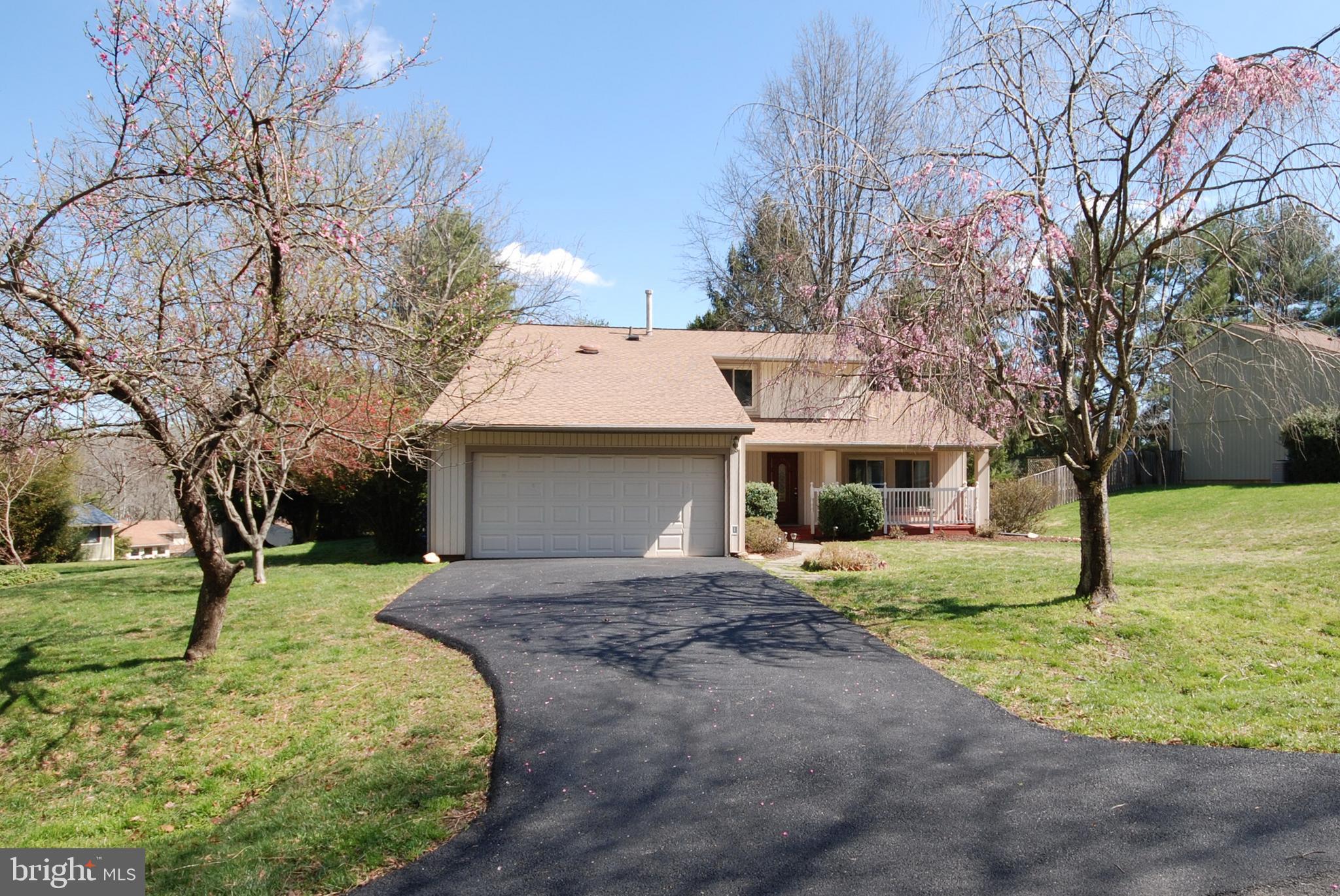 11609 Piney Lodge Road North Potomac, MD 20878 - Photo 4 of 25 a front view of a house with a yard garage and tree