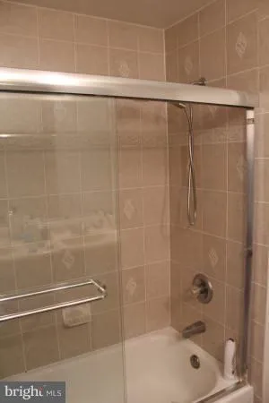 a bathroom with a shower and a bathtub