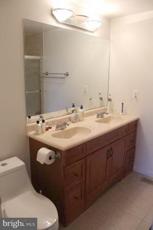 11609 Piney Lodge Road North Potomac, MD 20878 - Photo 9 of 25 a bathroom with a sink and mirror with toilet