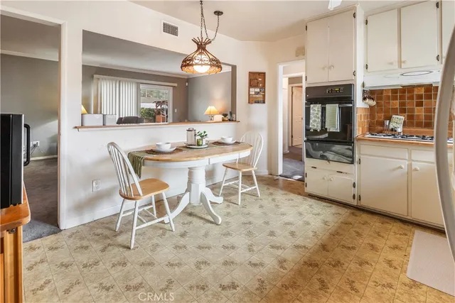a kitchen with stainless steel appliances kitchen island granite countertop a refrigerator and a stove top oven