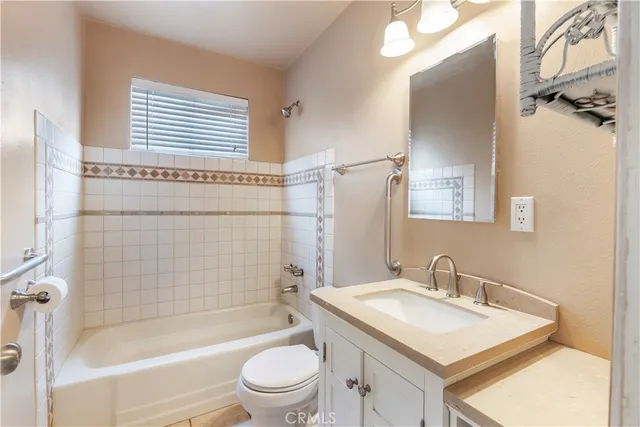 a bathroom with a sink toilet tub and shower