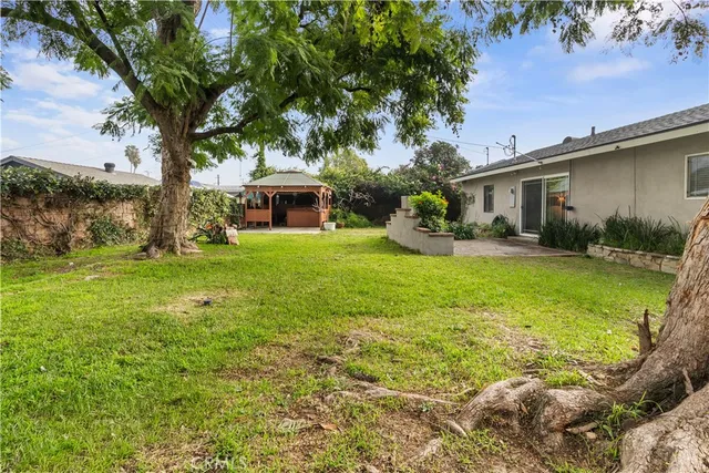 a backyard of a house with yard and outdoor seating