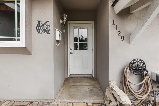 a front view of a livingroom with a sink and a mirror