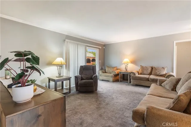 a living room with furniture a couch and potted plant