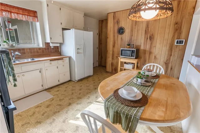 a kitchen with stainless steel appliances granite countertop a sink refrigerator and stove