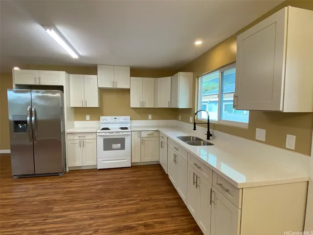 a kitchen with a white cabinets stove and refrigerator
