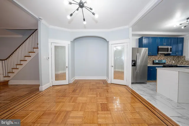 a view of a kitchen with a sink and a refrigerator wooden floor