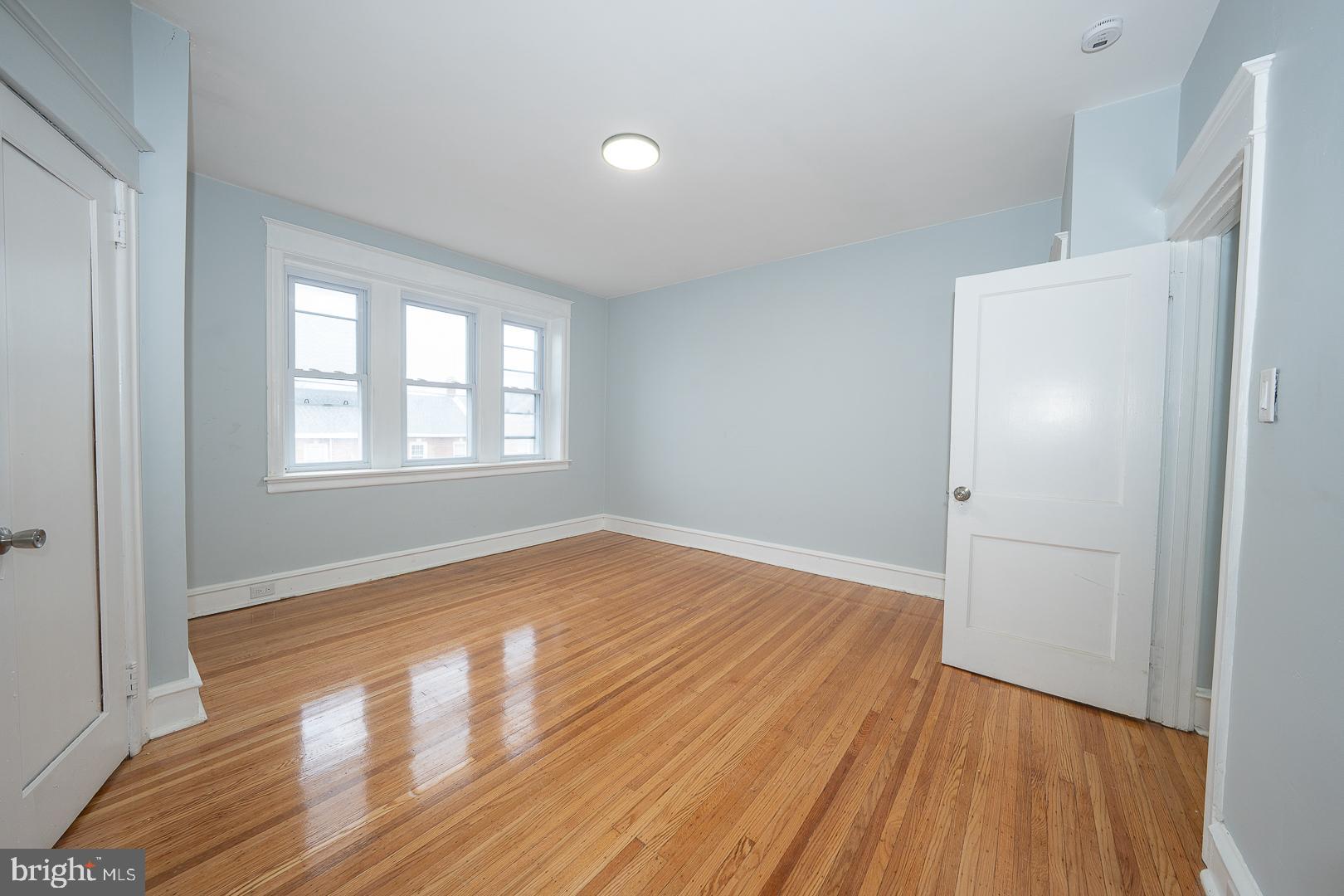 212 Copley Road Upper Darby, PA 19082 - Photo 28 of 69 an empty room with wooden floor and windows