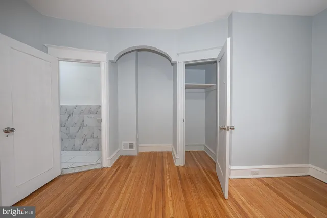 a view of room with window and wooden floor