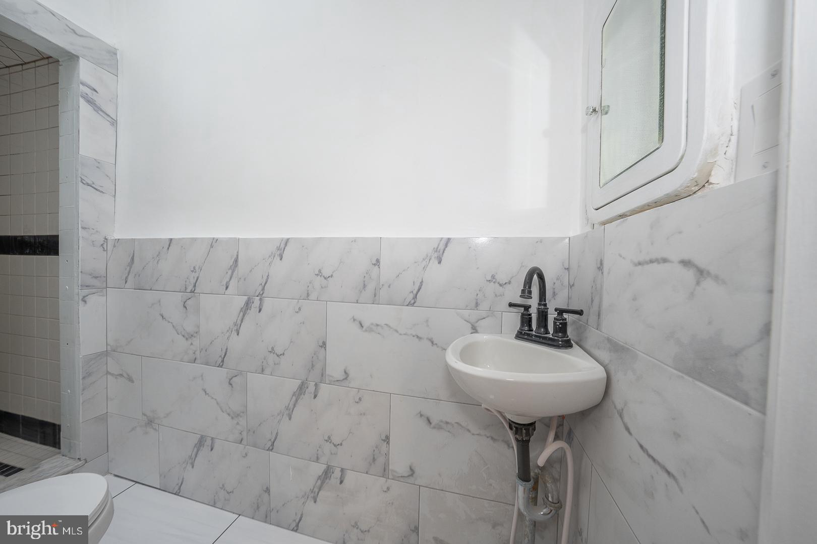 212 Copley Road Upper Darby, PA 19082 - Photo 31 of 69 a bathroom with a sink toilet and a mirror