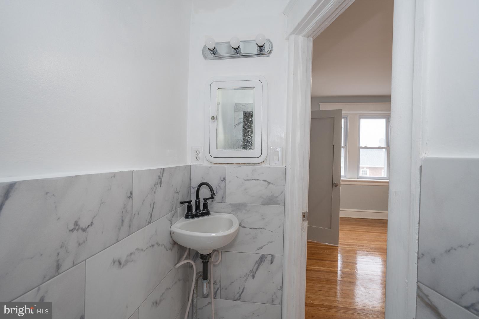 212 Copley Road Upper Darby, PA 19082 - Photo 35 of 69 a bathroom with a sink and mirror