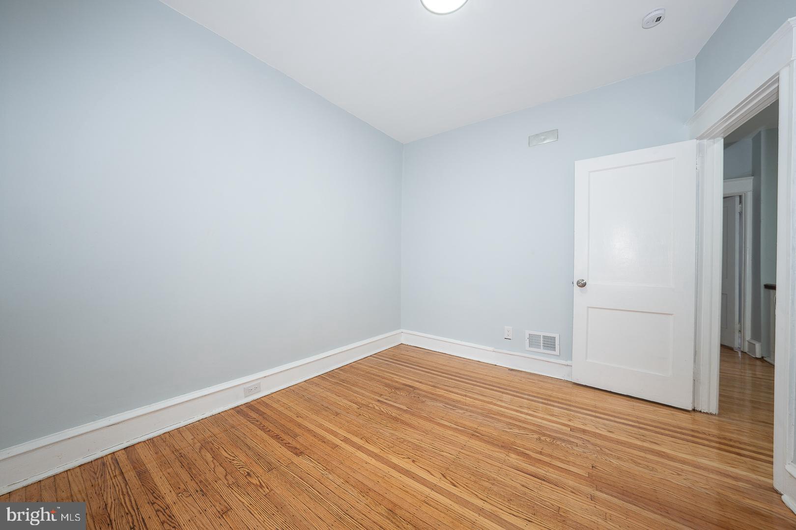 212 Copley Road Upper Darby, PA 19082 - Photo 43 of 69 a view of an empty room with wooden floor and a window