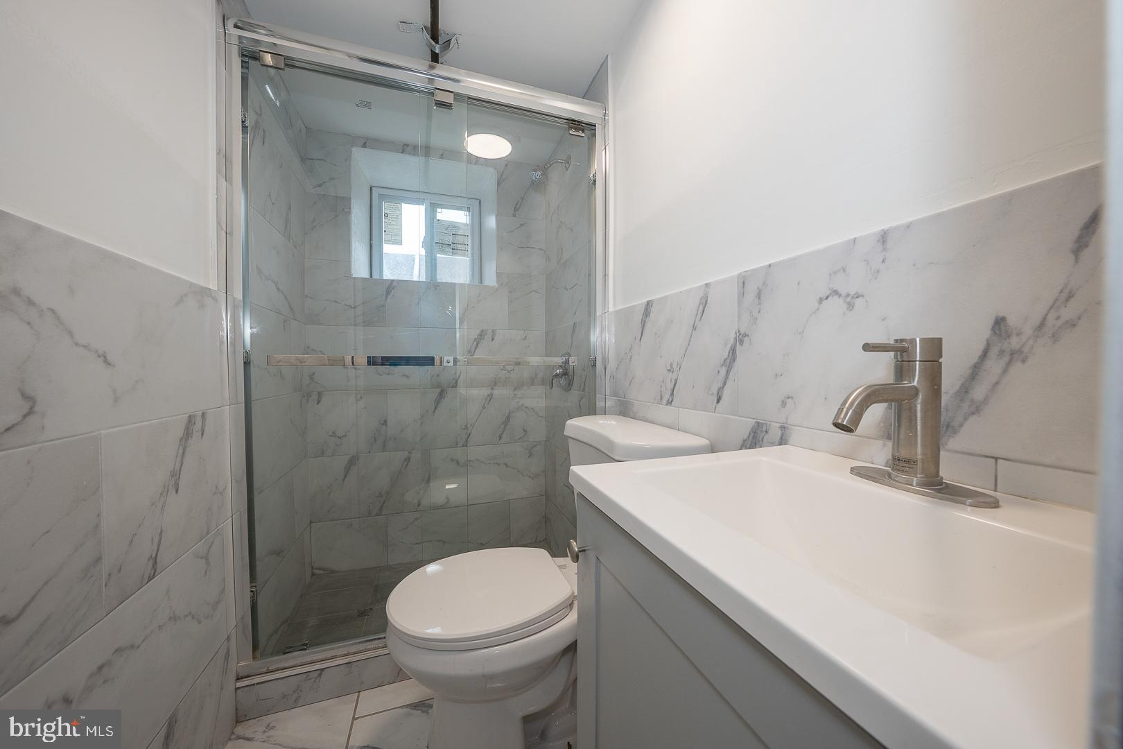 212 Copley Road Upper Darby, PA 19082 - Photo 52 of 69 a bathroom with a sink toilet and shower